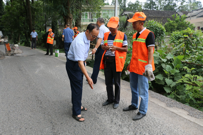 图3.兴仁公路管理段段长王福德在公路上指导养护人员安全施工.jpg